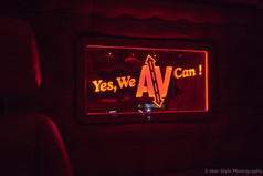 Beleuchteter Spiegel mit rotem Rahmen und sandgestrahltem Motiv "Yes, We AV Can!" im LKW-Innenraum.