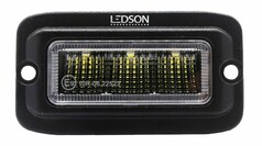 Schwarzer Ledson Raptor LED-Einbau R�ckfahr-/Arbeitsscheinwerfer mit klarem Glas und gelben LEDs.