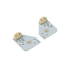 Ein Paar grauer Tagfahrlicht-Platinen mit bernsteinfarbenen LEDs und Steckern f�r Scania NG.