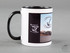 Keramik Tasse wei� mit schwarzem Henkel und Rand. Bedruckt mit Anker-Motiven und 